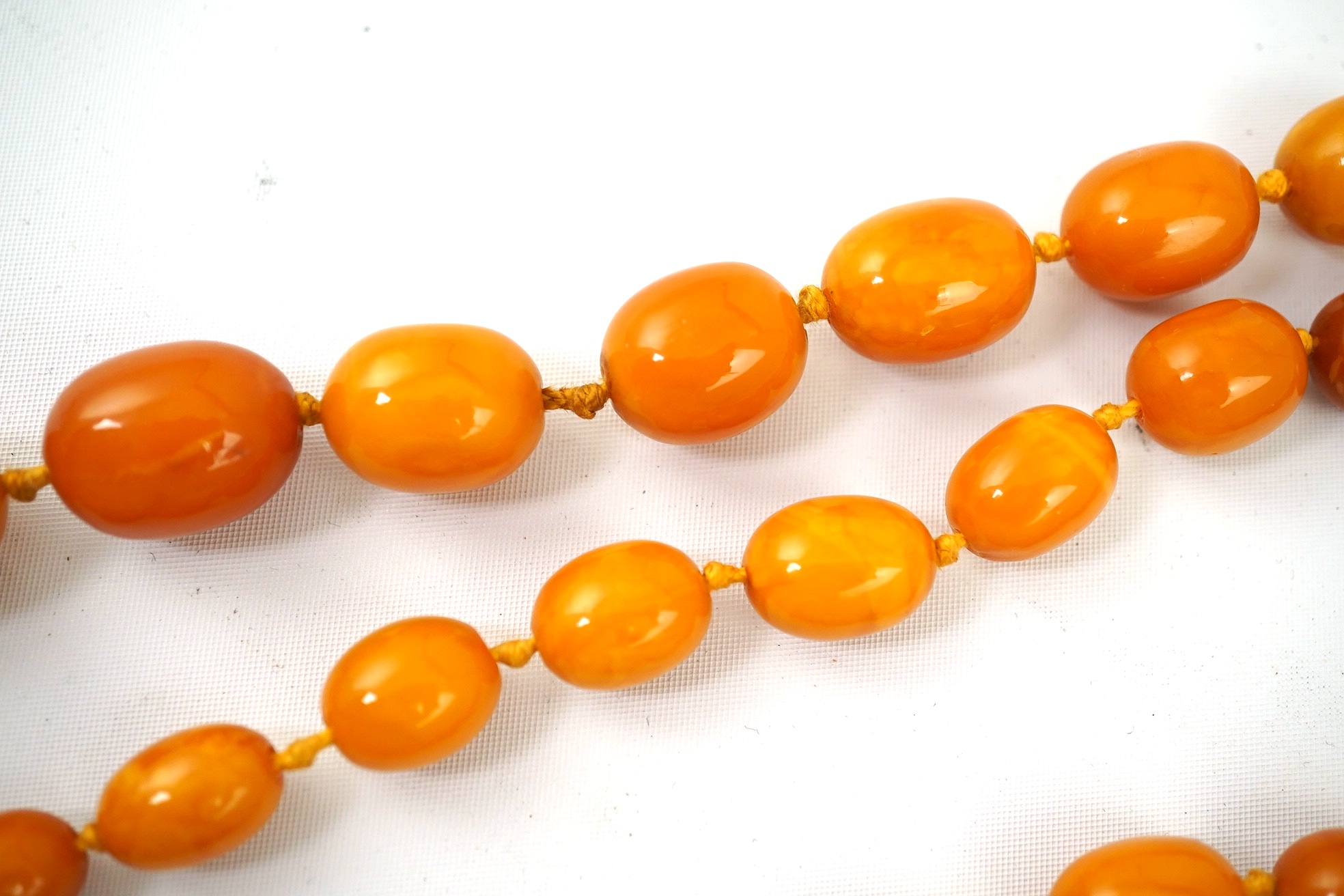 A single strand graduated oval amber bead necklace